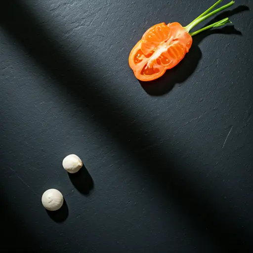 Minimalist top-down view of fresh ingredients on a dark stone surface